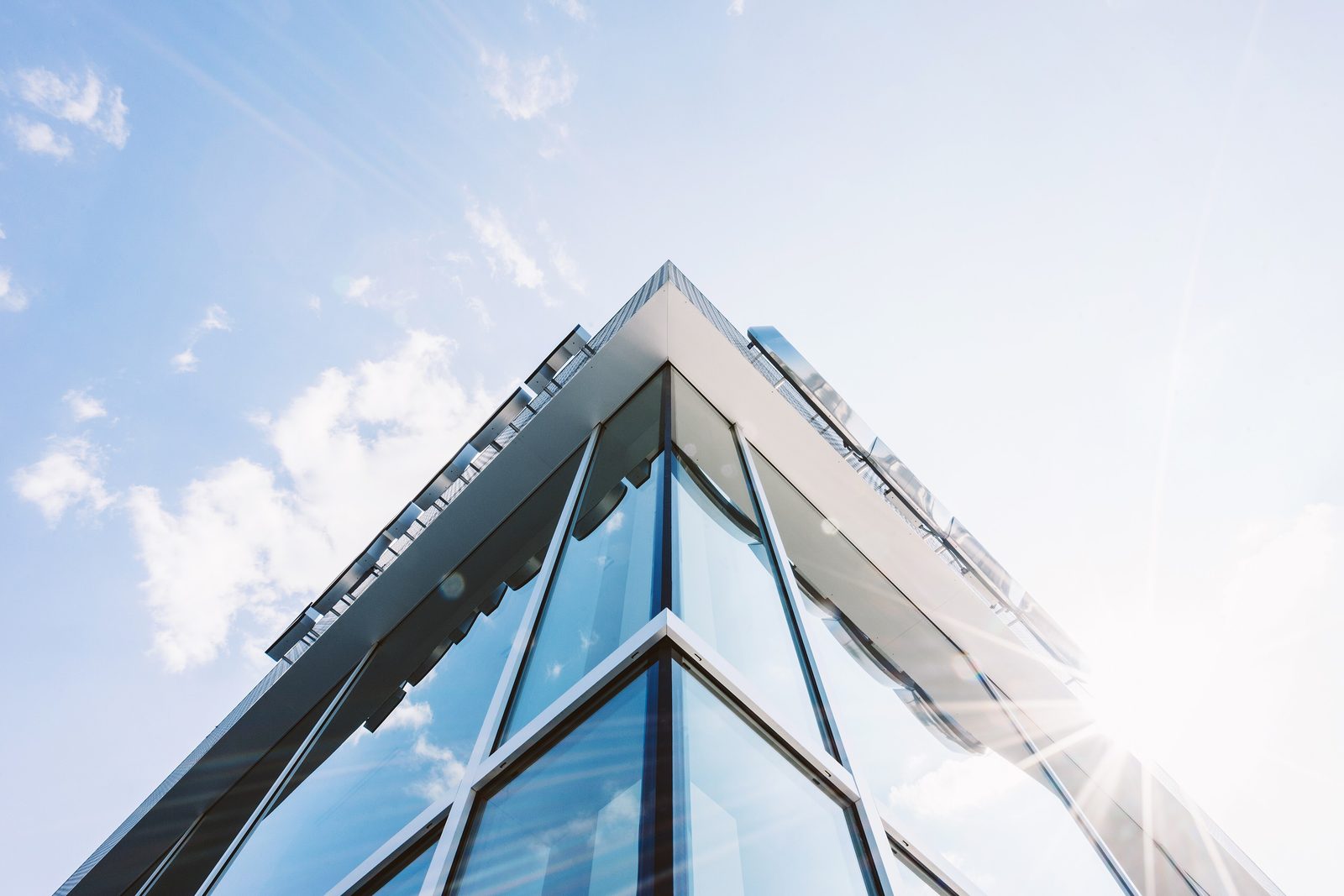 Glass office building against a sunny sky